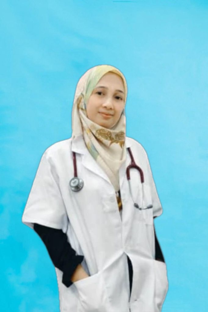 Dr amira in white coat and stethoscope in front of a light blue background