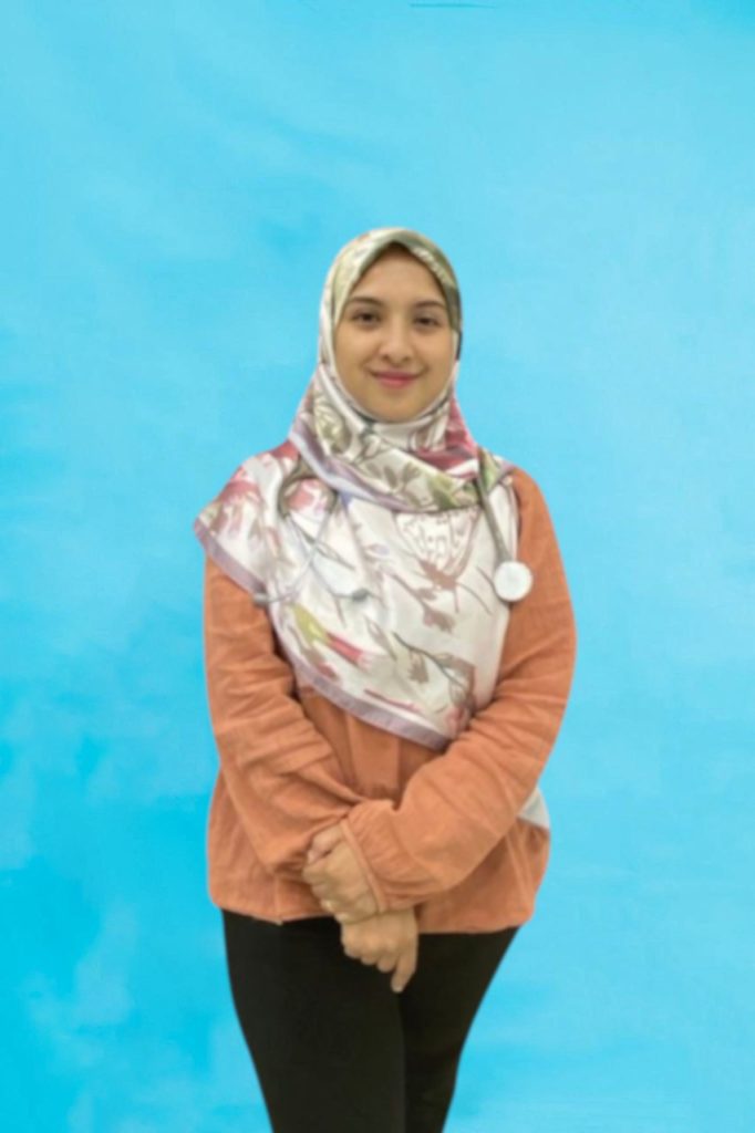 Dr mariati with a stethoscope in front of a light blue background